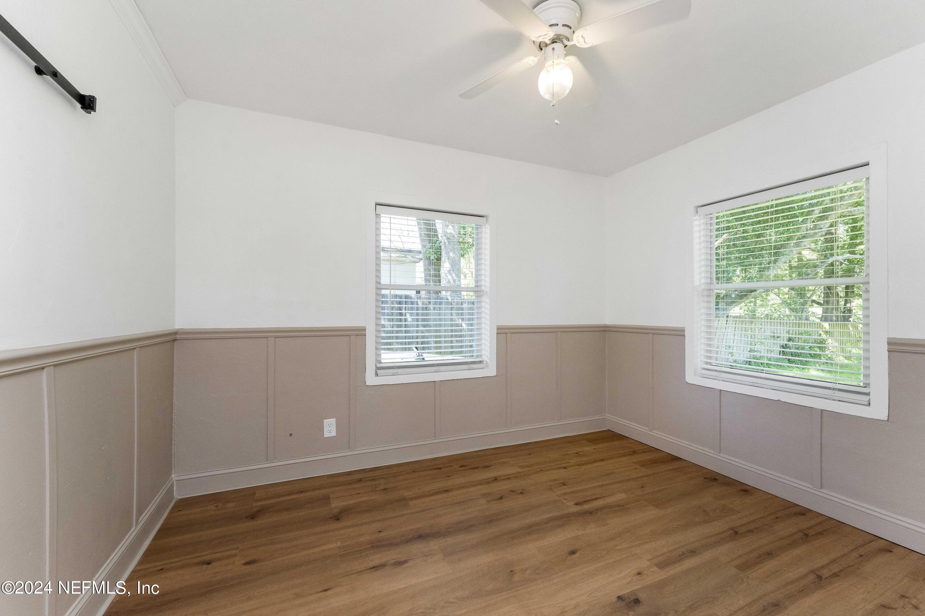 3651 Peach Drive Jacksonville, FL 32246 - Photo 15 of 25 a view of an empty room with wooden floor and a window