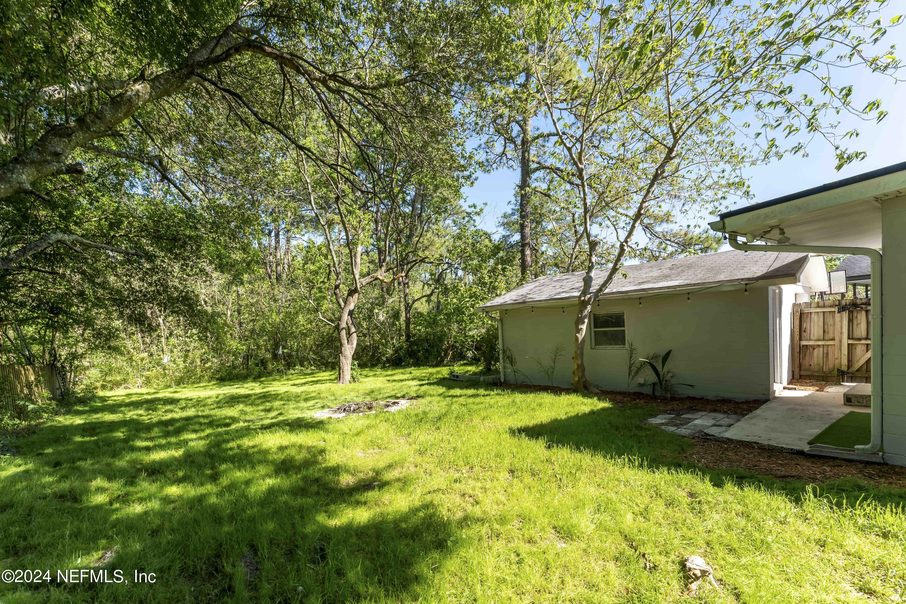 3651 Peach Drive Jacksonville, FL 32246 - Photo 20 of 25 a view of a backyard with large trees