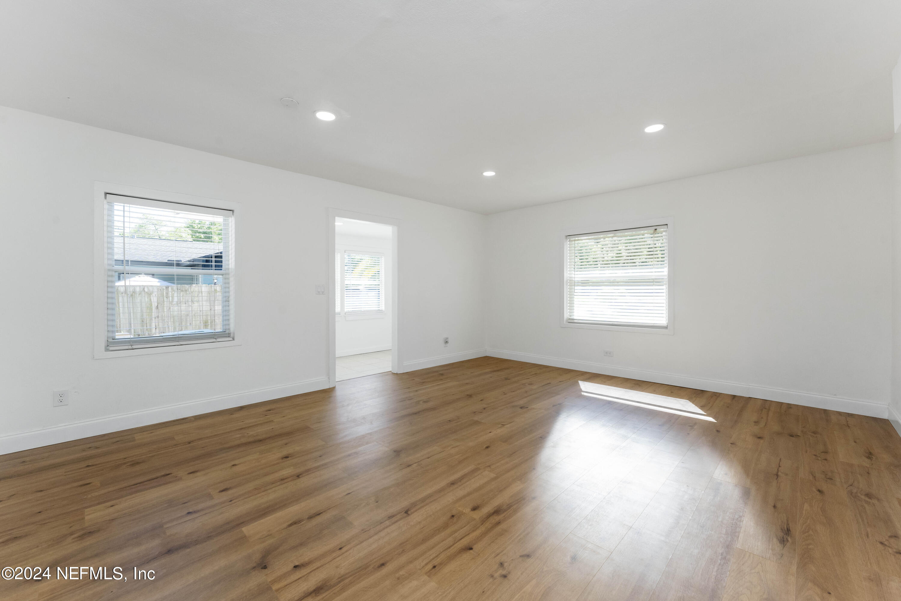 3651 Peach Drive Jacksonville, FL 32246 - Photo 6 of 25 a view of an empty room with wooden floor and a window