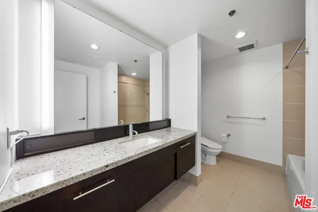 a bathroom with a toilet and bathtub