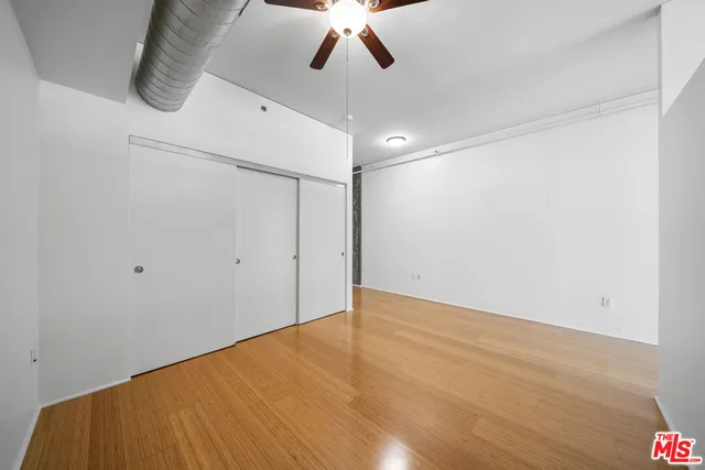 a kitchen with stainless steel appliances granite countertop a refrigerator a stove and a wooden floors