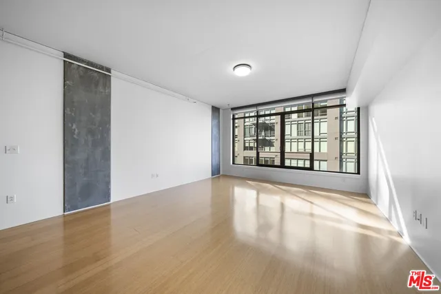 a kitchen with stainless steel appliances kitchen island granite countertop a stove and a refrigerator