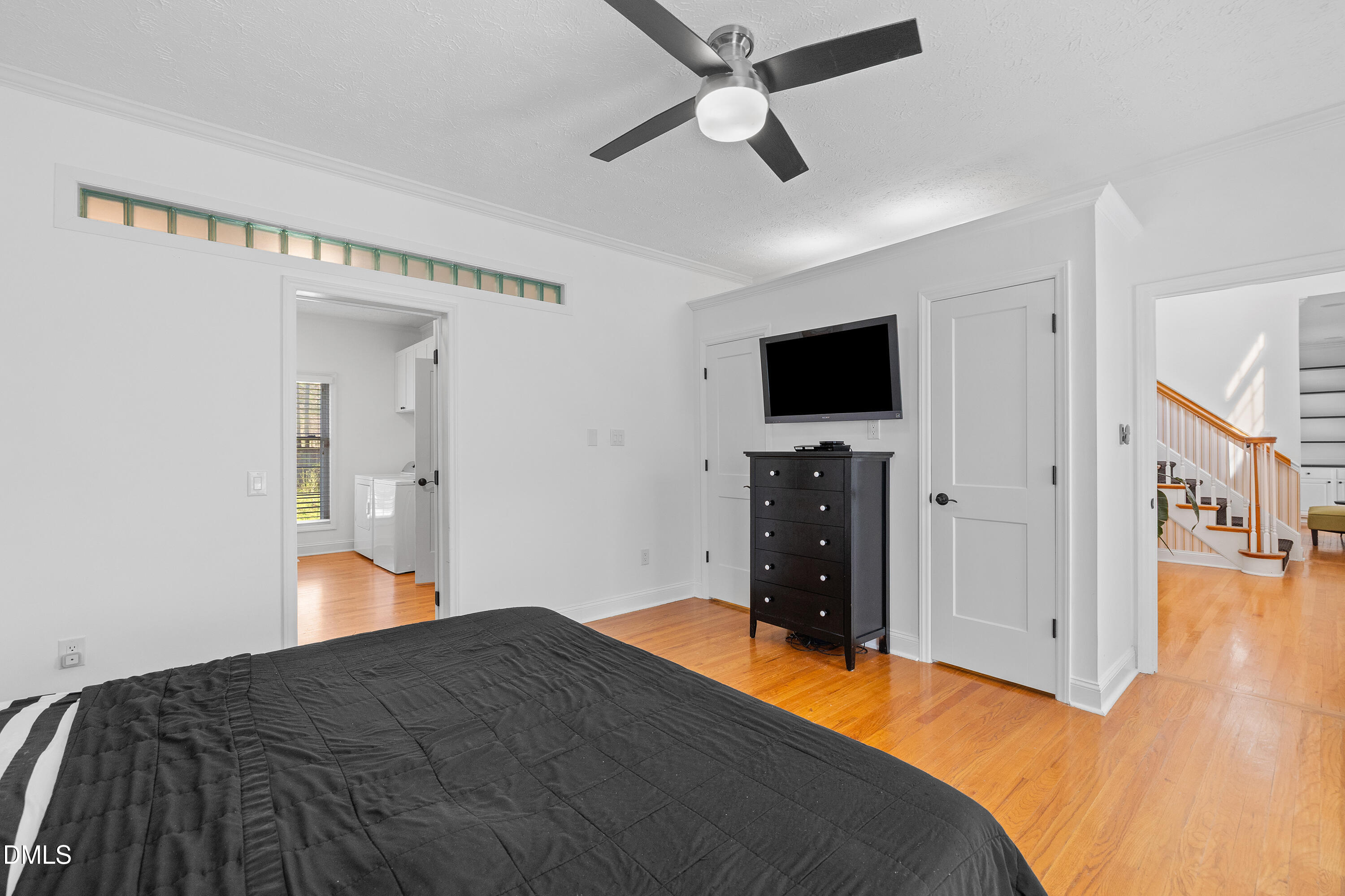 340 Andrews Store Road Pittsboro, NC 27312 - Photo 26 of 59 a bedroom with a bed and a flat tv screen on a dresser