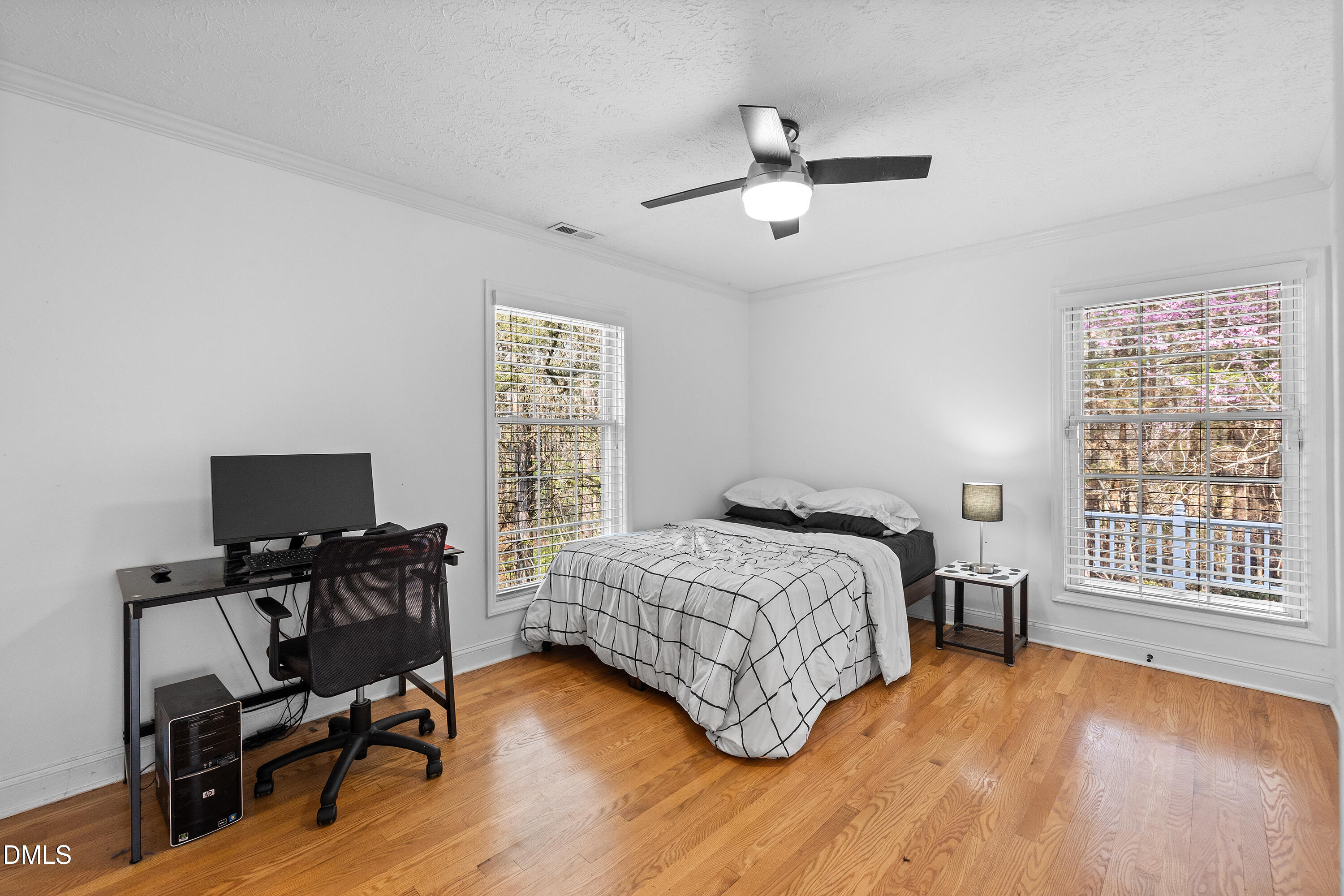 340 Andrews Store Road Pittsboro, NC 27312 - Photo 41 of 59 a bedroom with a bed a desk and chair with wooden floor