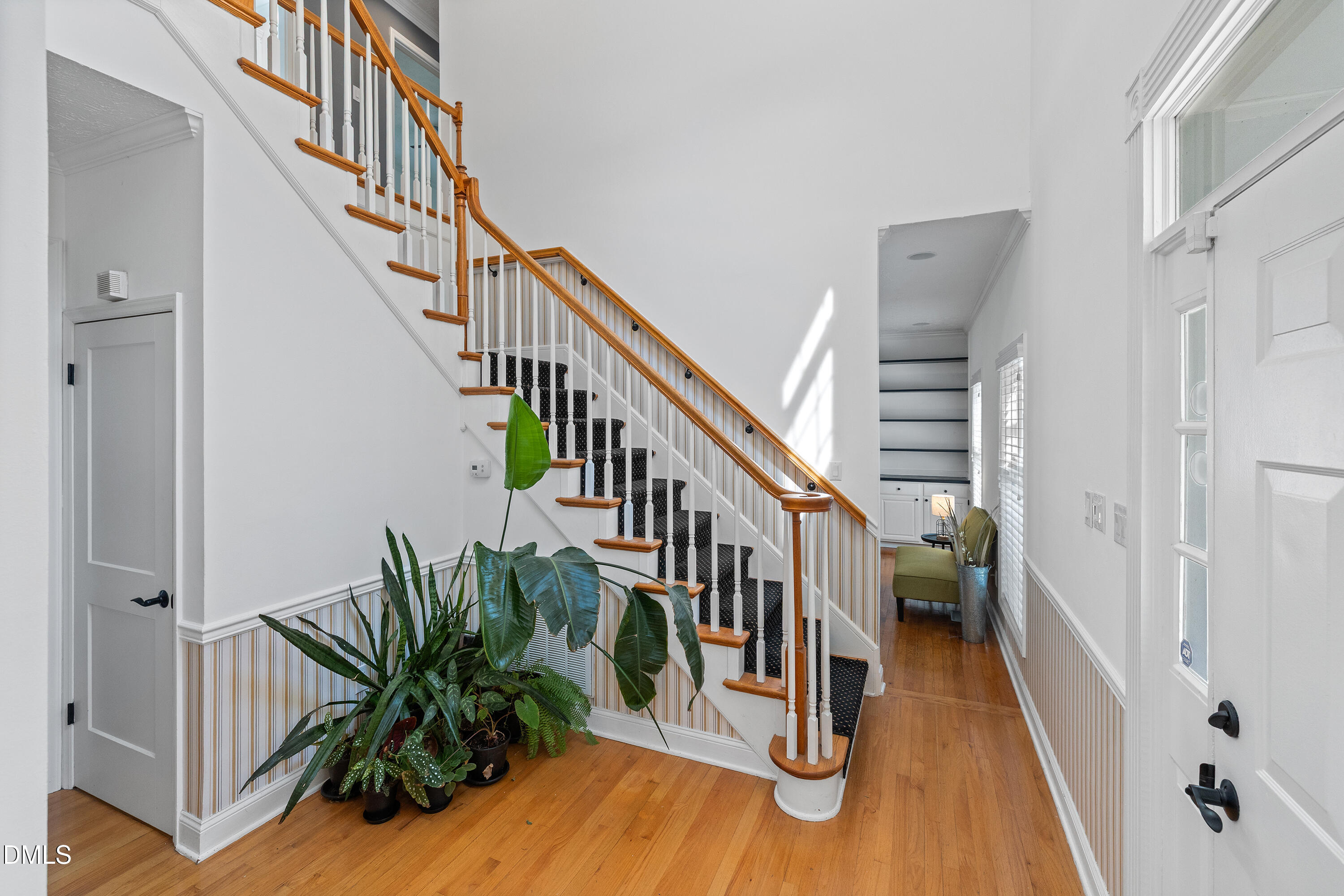 340 Andrews Store Road Pittsboro, NC 27312 - Photo 6 of 59 a view of staircase with lots of frames on wall and wooden floor