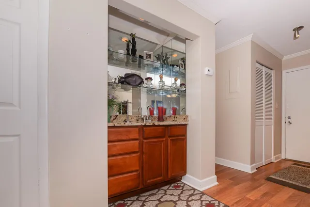 a dining room with a wooden floor and cabinets