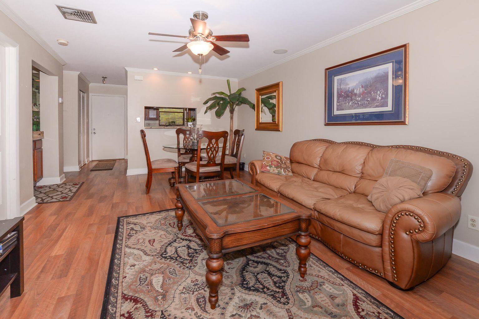 2050 Oleander Boulevard, Unit 2202 Fort Pierce, FL 34950 - Photo 3 of 15 a living room with furniture a wooden floor and a chandelier