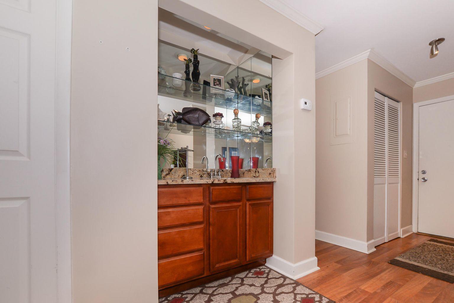 2050 Oleander Boulevard, Unit 2202 Fort Pierce, FL 34950 - Photo 5 of 15 a dining room with a mirror and cabinets