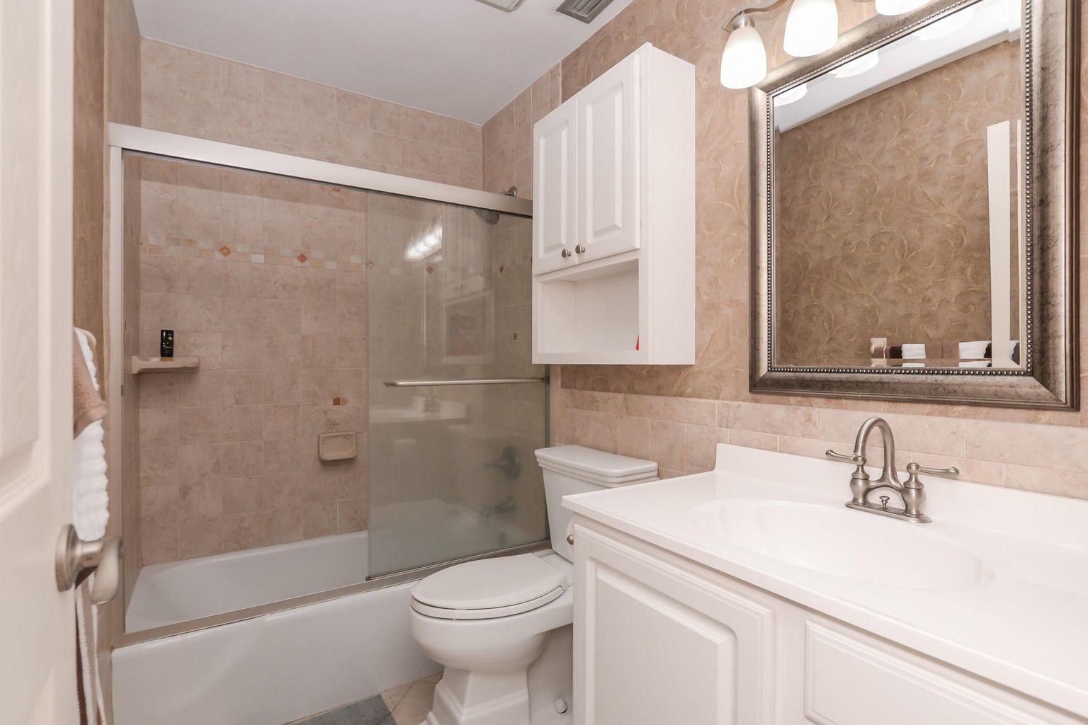 2050 Oleander Boulevard, Unit 2202 Fort Pierce, FL 34950 - Photo 7 of 15 a bathroom with a sink a toilet and shower