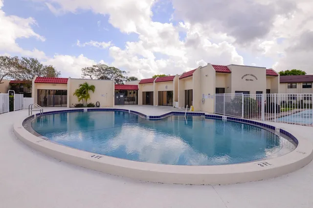 a view of a house with swimming pool and sitting area