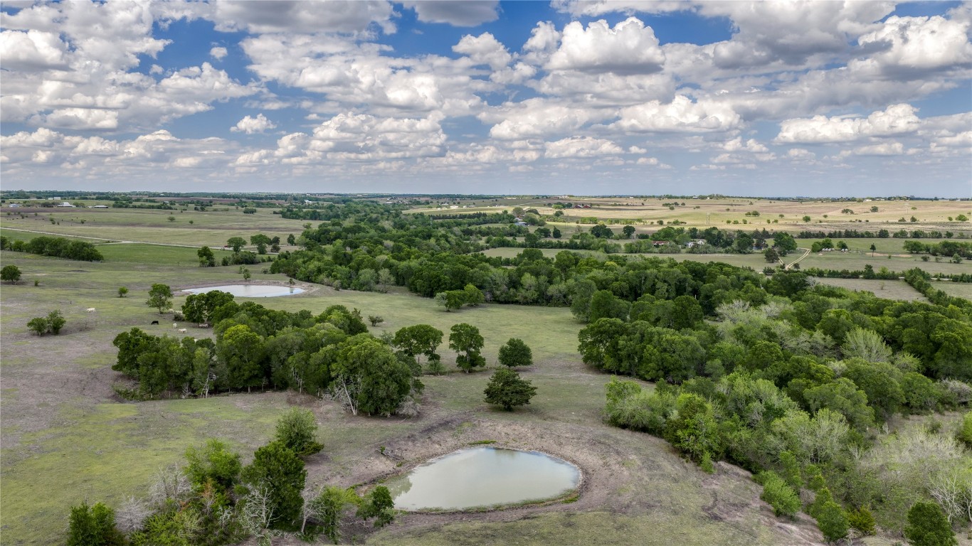 6807 Winedale Road Burton, TX 77835 - Photo 16 of 24 a view of a lake with houses in the back