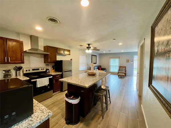 a kitchen with a sink a counter top space a stove and cabinets