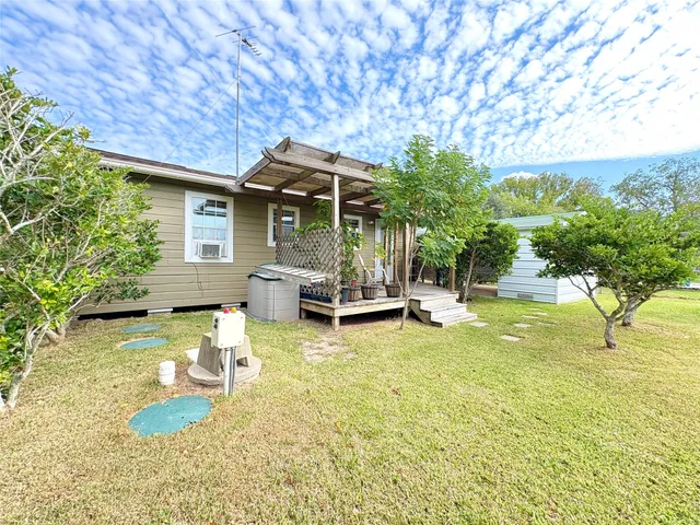 a view of a backyard with swimming pool