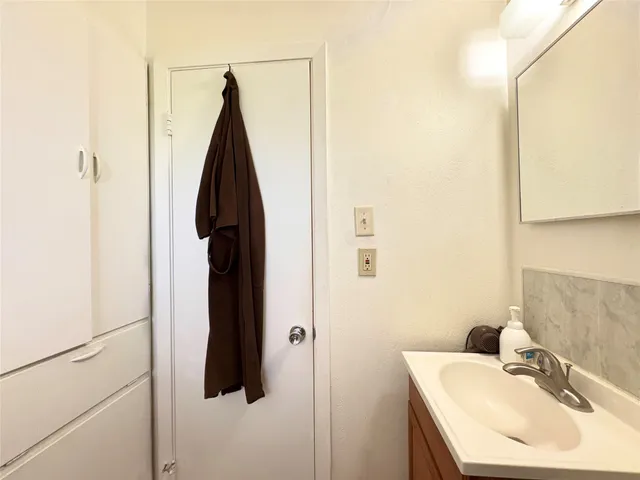 a bathroom with a sink and mirror