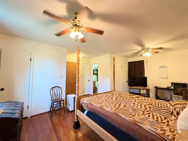 a spacious bedroom with a bed and a chandelier