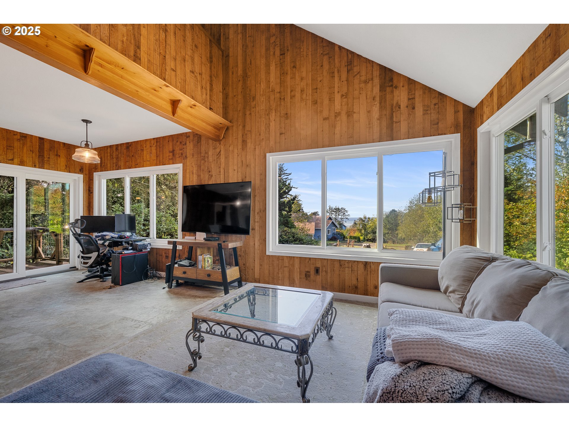 4900 Clam Way Tillamook, OR 97141 - Photo 14 of 30 a living room with furniture a flat screen tv and a large window