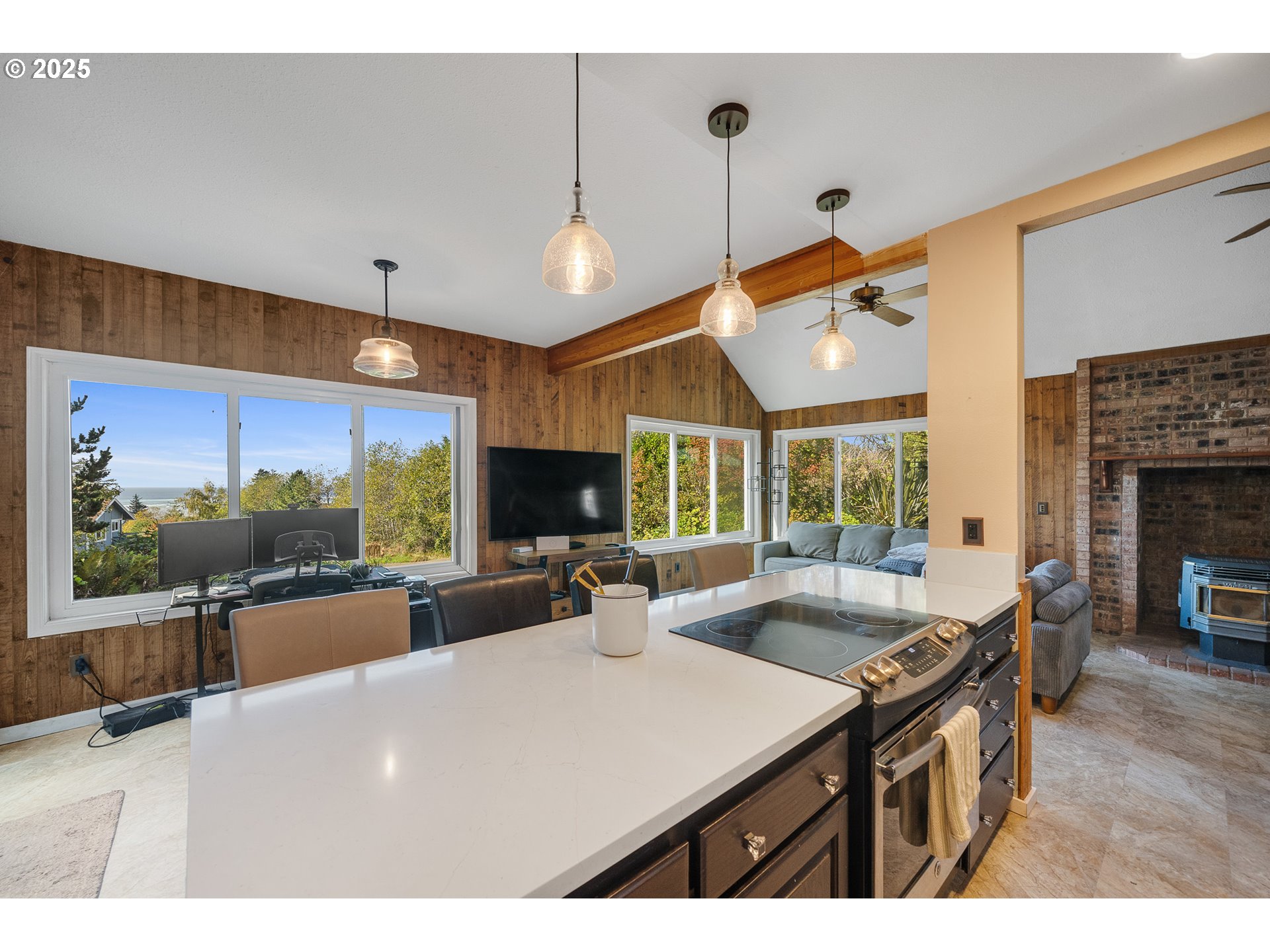 4900 Clam Way Tillamook, OR 97141 - Photo 16 of 30 a living room with furniture a flat screen tv and a large window