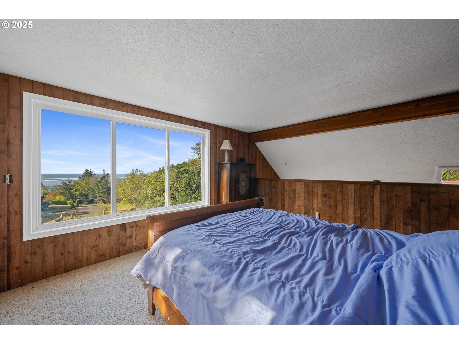 4900 Clam Way Tillamook, OR 97141 - Photo 22 of 30 a bedroom with a bed and a large window