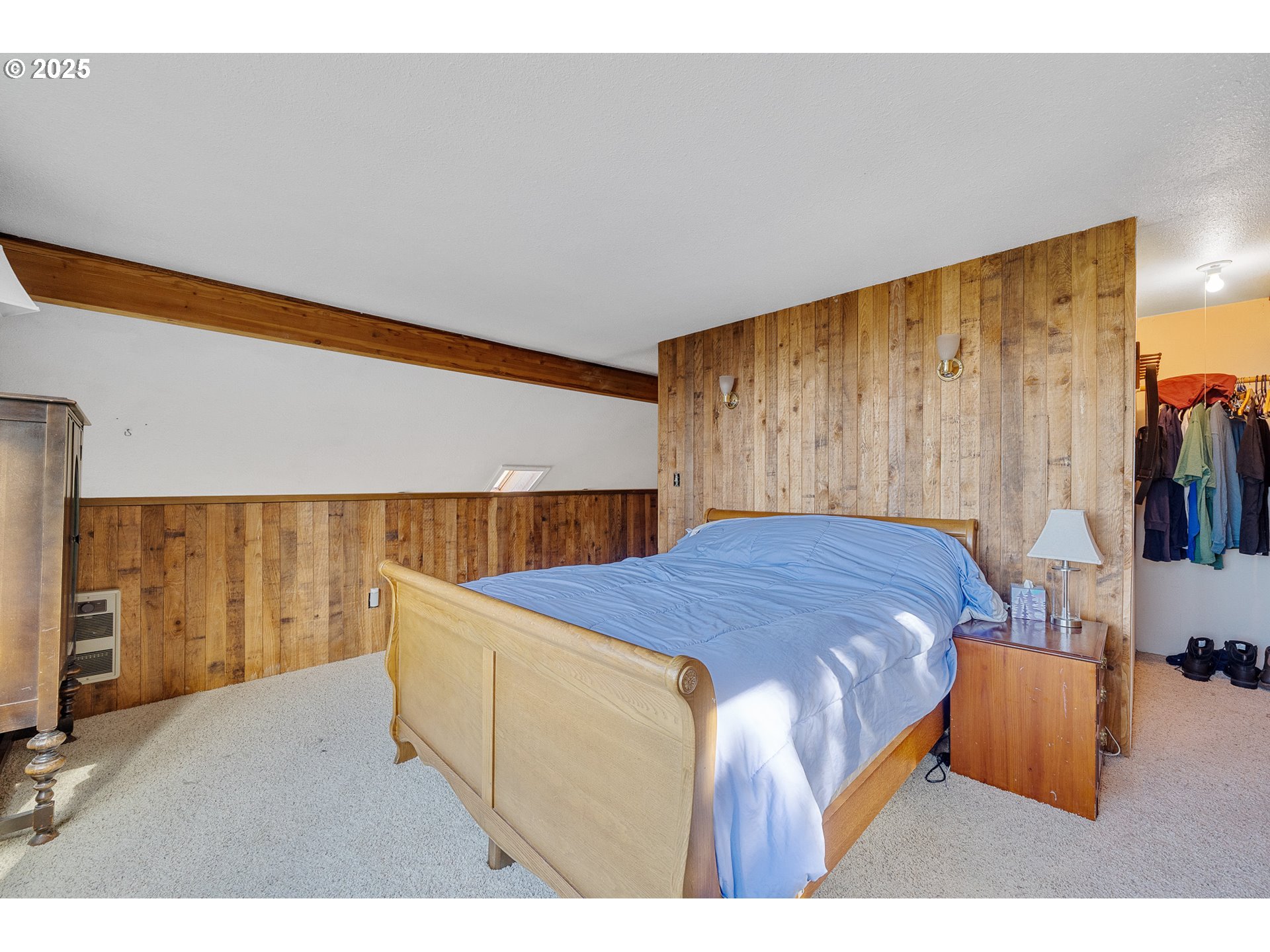 4900 Clam Way Tillamook, OR 97141 - Photo 24 of 30 a bedroom with a bed and a flat screen tv