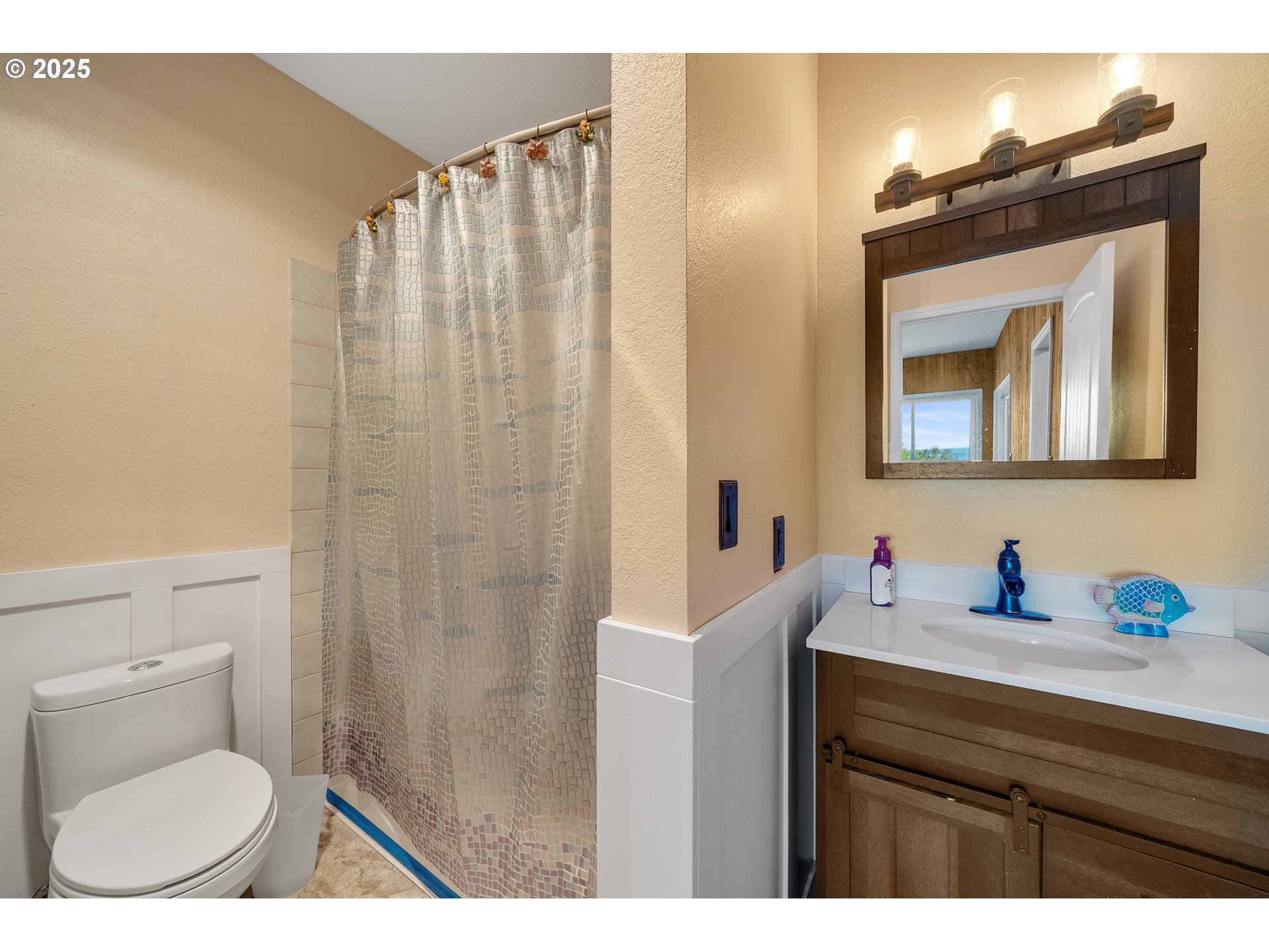 4900 Clam Way Tillamook, OR 97141 - Photo 26 of 30 a bathroom with a sink vanity mirror and toilet