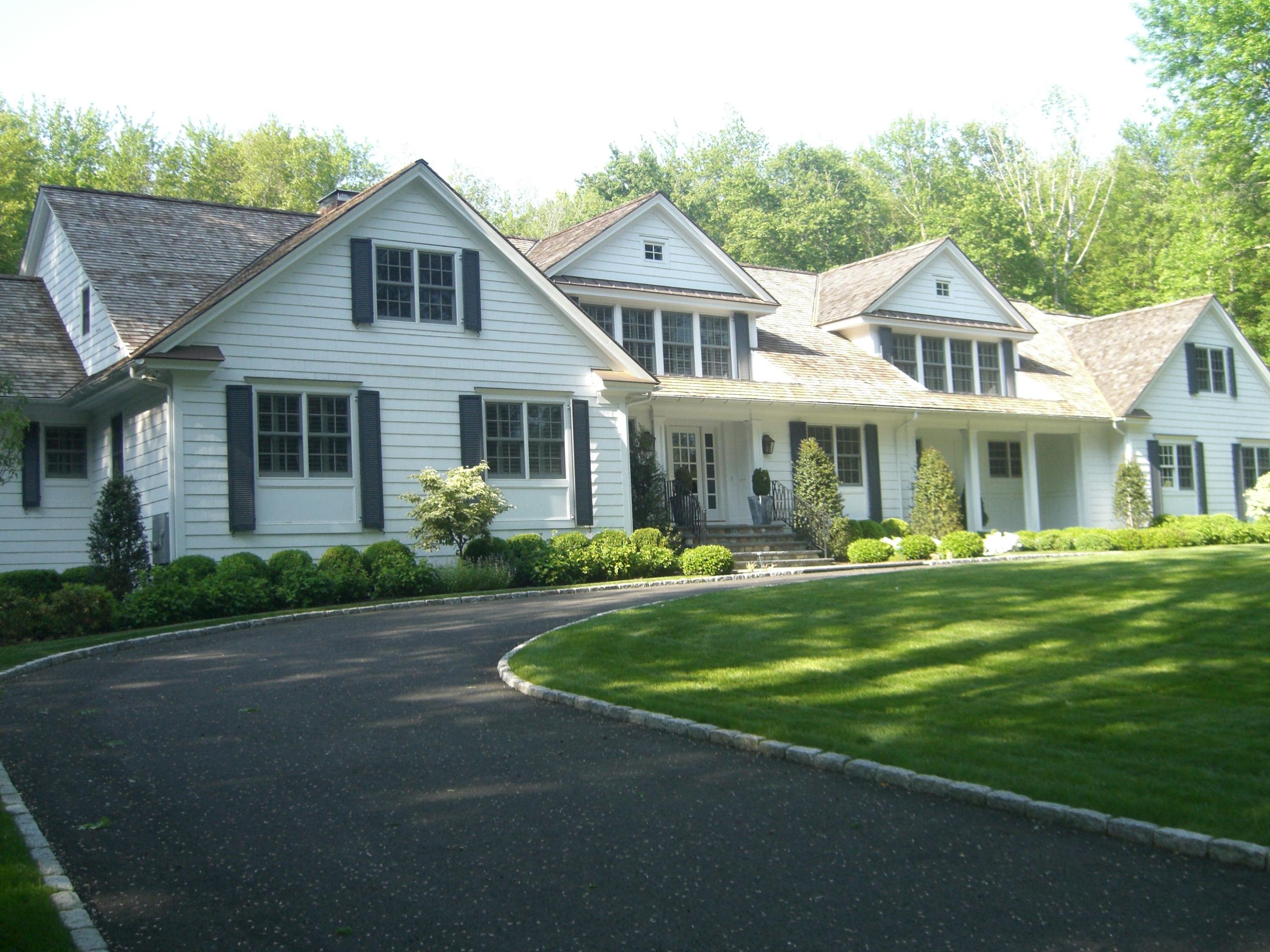 183 Turtle Back Road New Canaan, CT 06840 - Photo 2 of 53 a front view of a house with a garden and porch