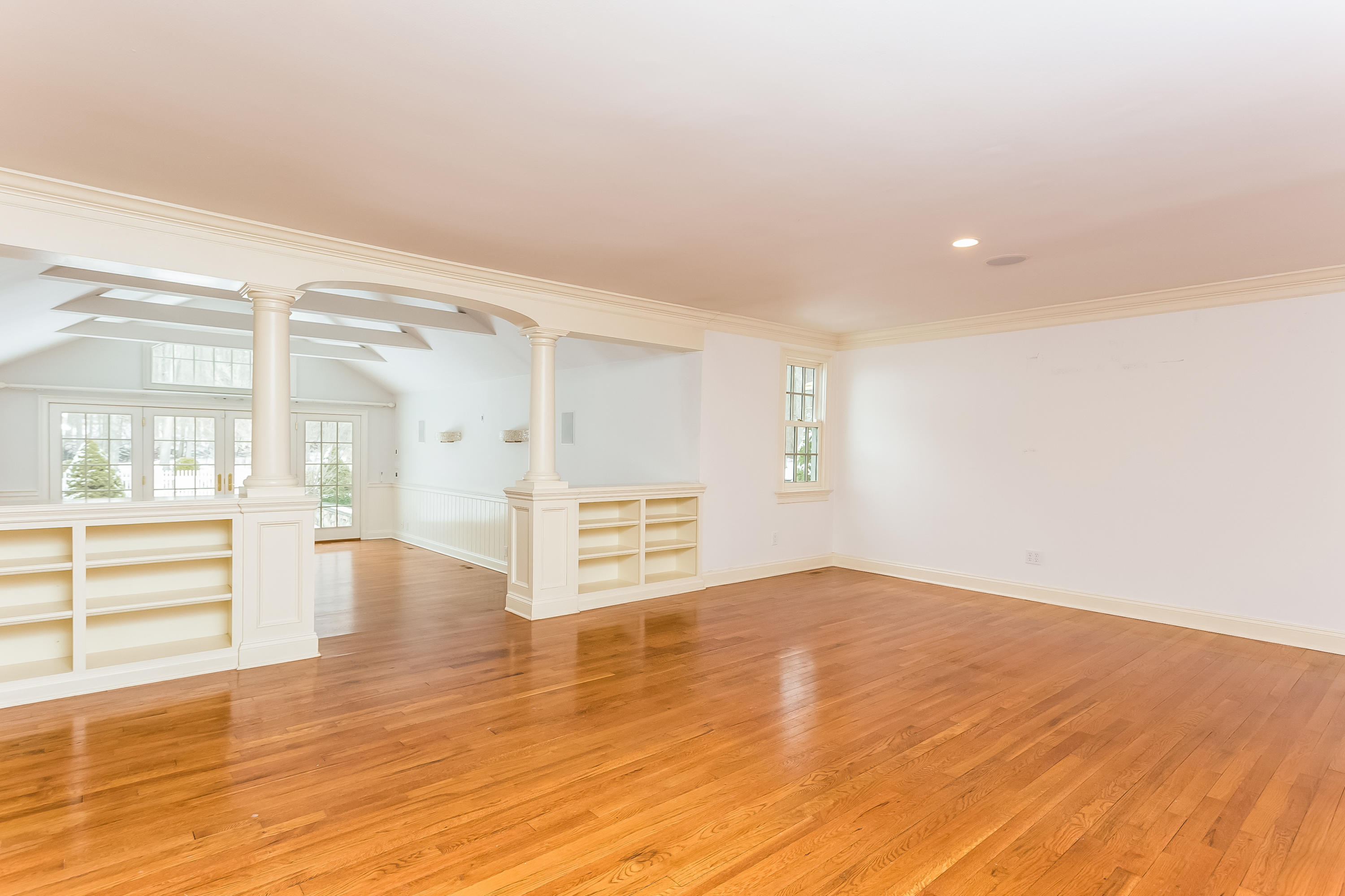 183 Turtle Back Road New Canaan, CT 06840 - Photo 17 of 53 an empty room with wooden floor and windows