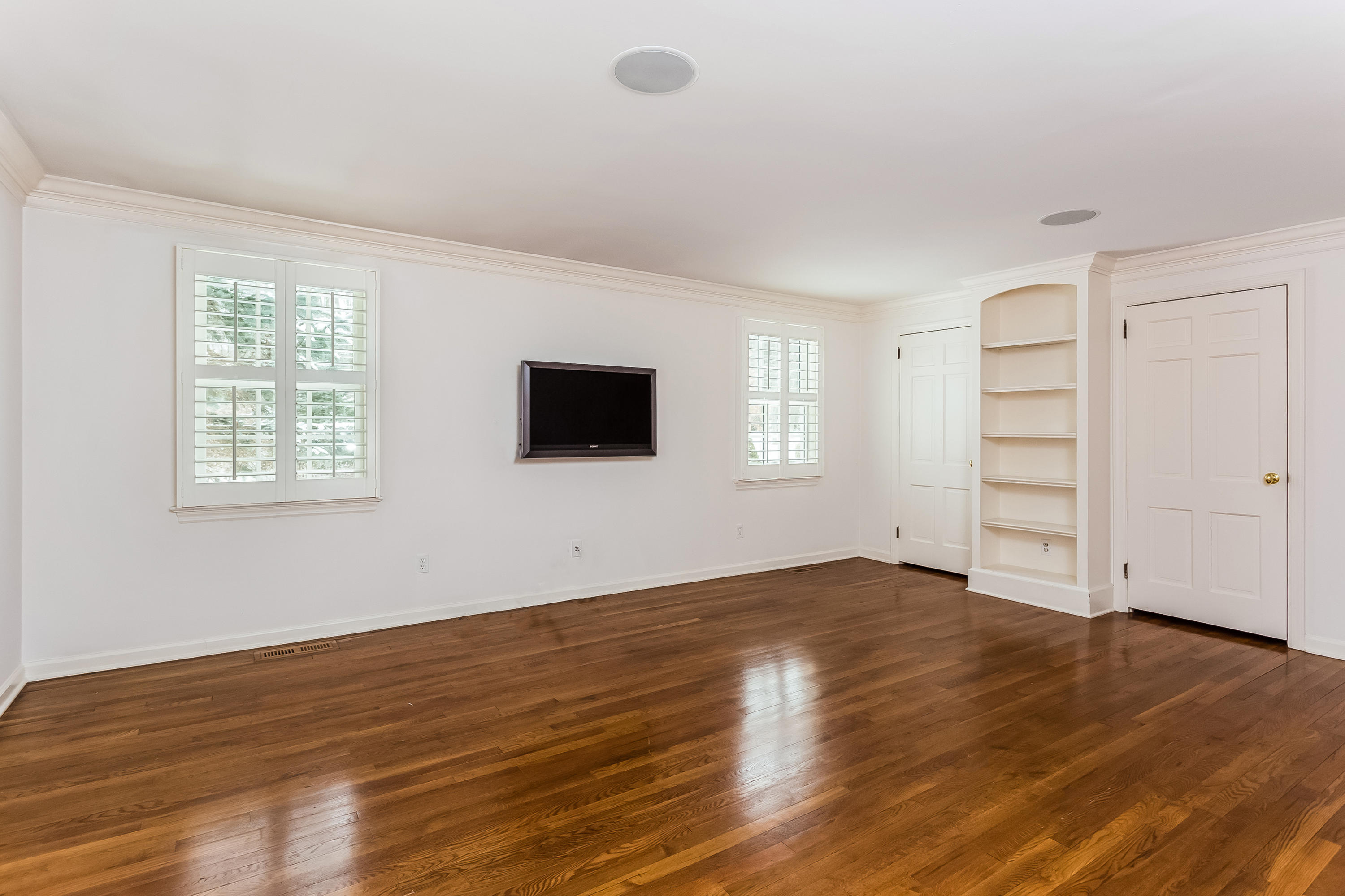 183 Turtle Back Road New Canaan, CT 06840 - Photo 23 of 53 a view of an empty room with wooden floor and windows
