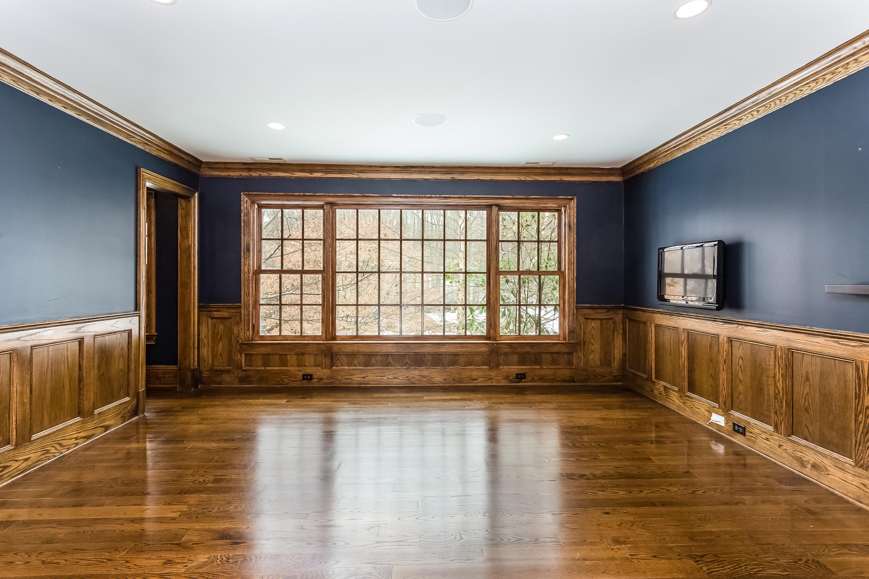 183 Turtle Back Road New Canaan, CT 06840 - Photo 34 of 53 a view of an empty room with wooden floor and a window