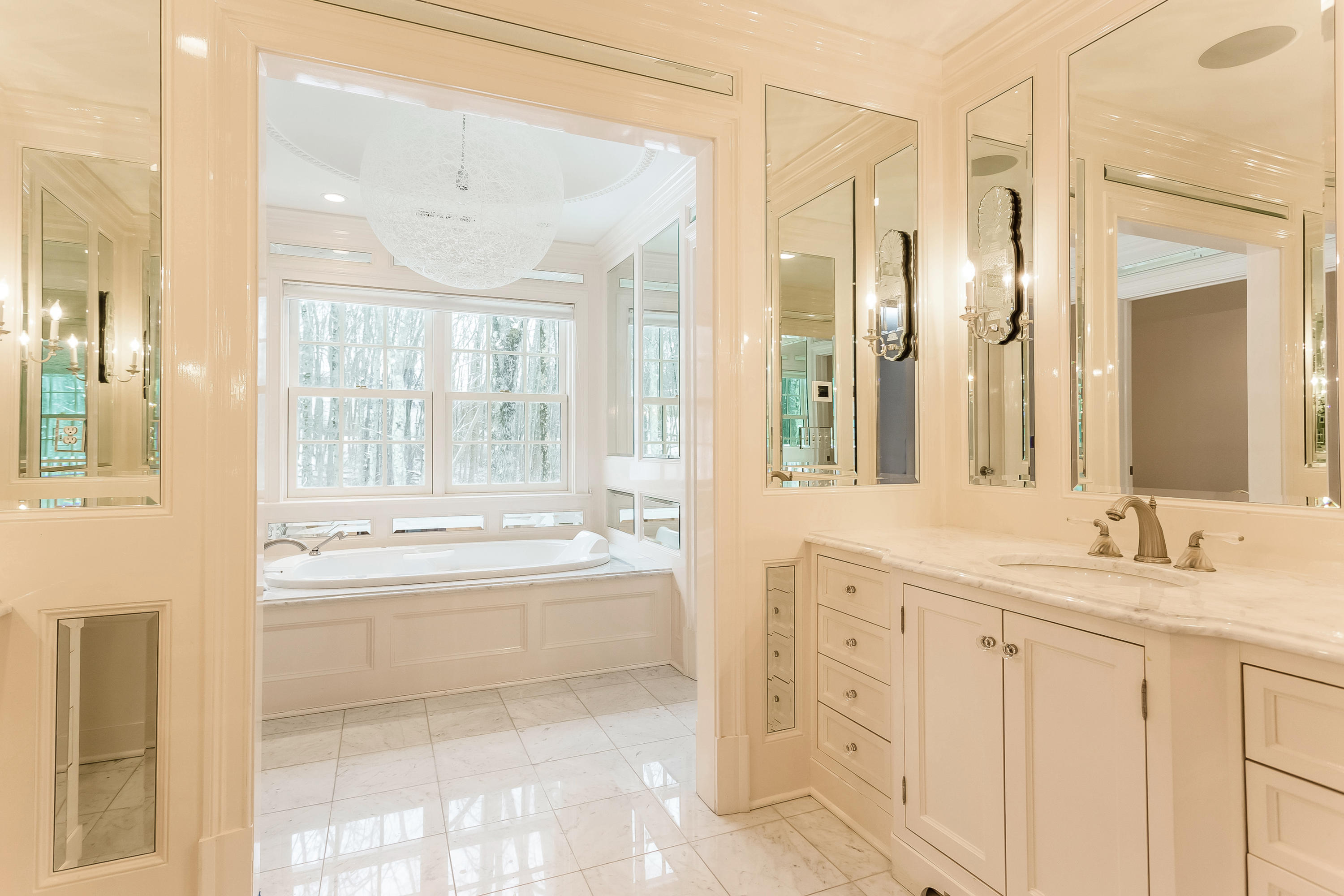 183 Turtle Back Road New Canaan, CT 06840 - Photo 39 of 53 a spacious bathroom with a granite countertop sink a mirror and a bathtub