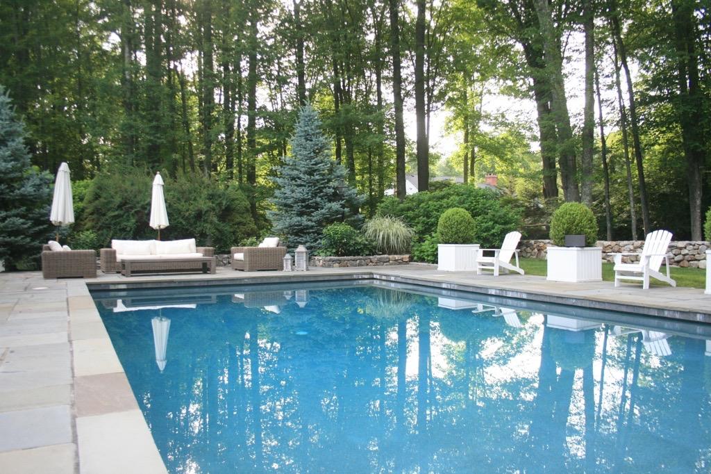 183 Turtle Back Road New Canaan, CT 06840 - Photo 5 of 53 a view of a swimming pool with a patio