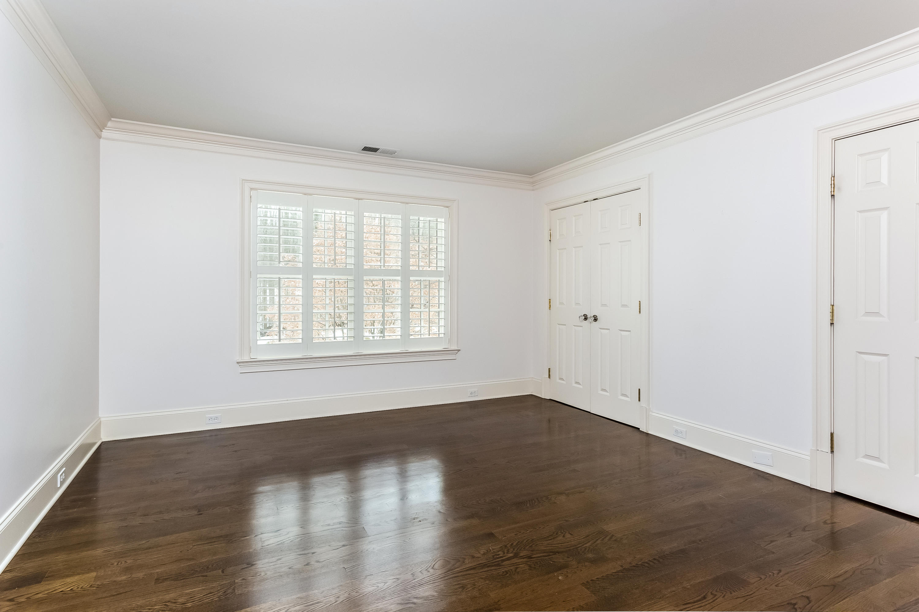 183 Turtle Back Road New Canaan, CT 06840 - Photo 41 of 53 a view of an empty room with wooden floor and a window