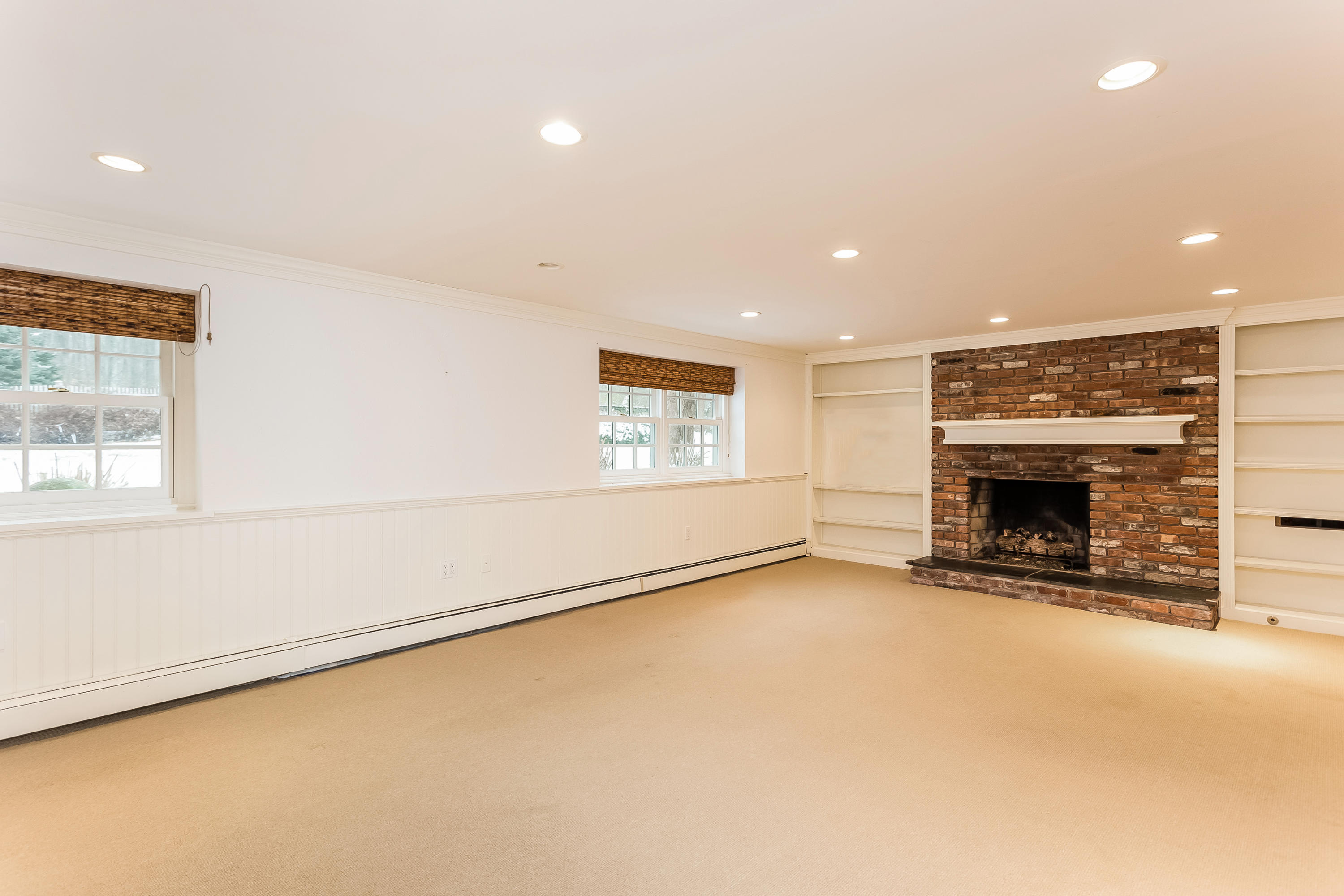 183 Turtle Back Road New Canaan, CT 06840 - Photo 45 of 53 an empty room with a fireplace and window