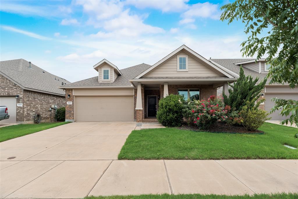 1601 Bunting Drive Argyle, TX 76226 - Photo 1 of 1 View of front facade featuring brick siding, a garage, driveway, and a front yard