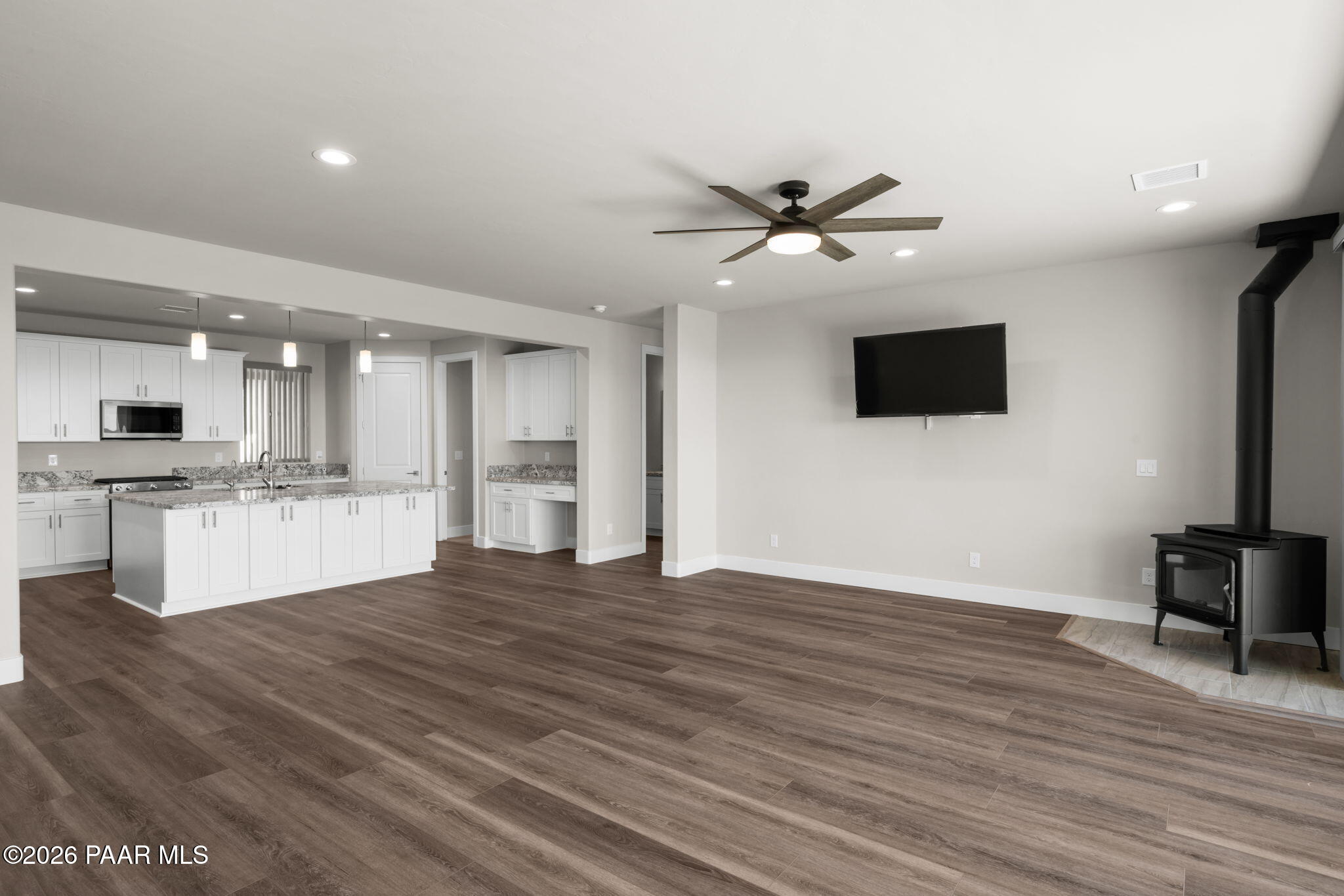 15689 East Orch Vw Road Dewey, AZ 86327 - Photo 13 of 39 a view of an empty room with wooden floor and a kitchen