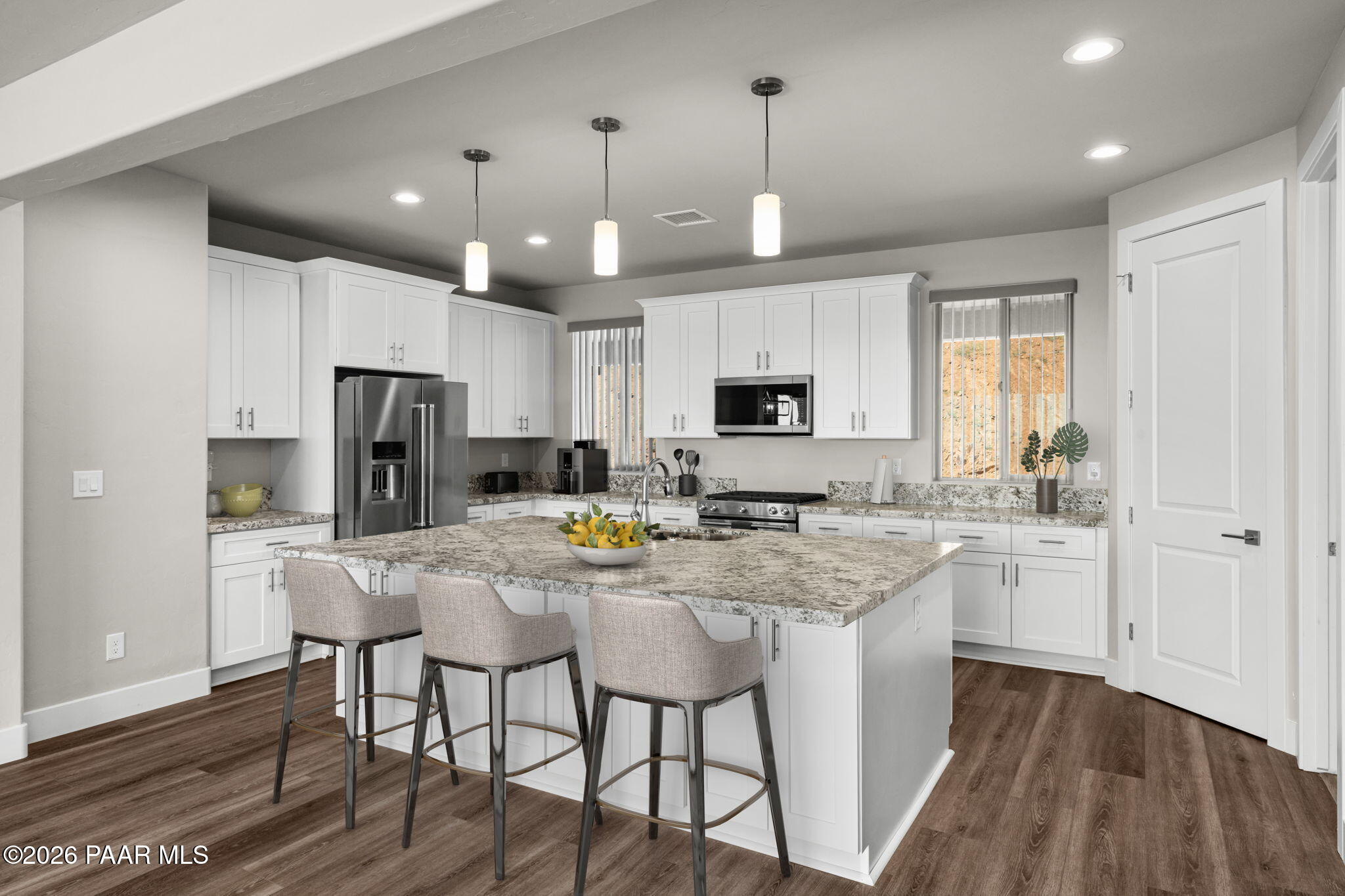 15689 East Orch Vw Road Dewey, AZ 86327 - Photo 2 of 39 a kitchen with stainless steel appliances kitchen island granite countertop a table chairs refrigerator and microwave