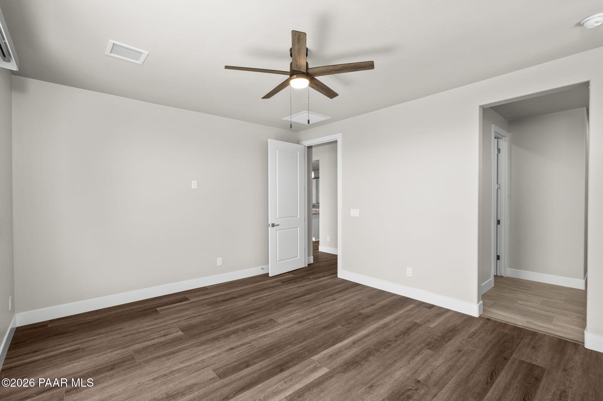 15689 East Orch Vw Road Dewey, AZ 86327 - Photo 26 of 39 an empty room with wooden floor ceiling fan and window