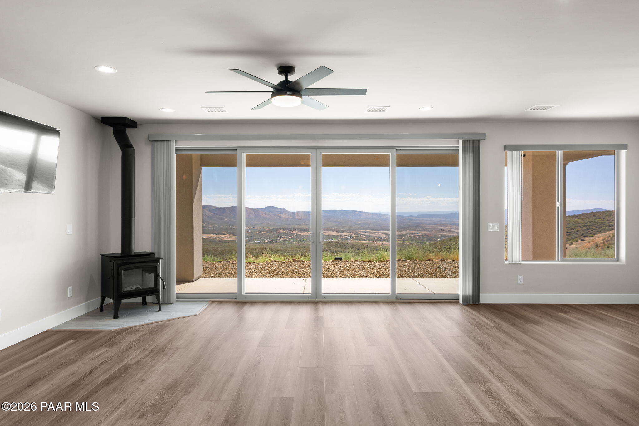 15689 East Orch Vw Road Dewey, AZ 86327 - Photo 7 of 39 an empty room with wooden floor and windows