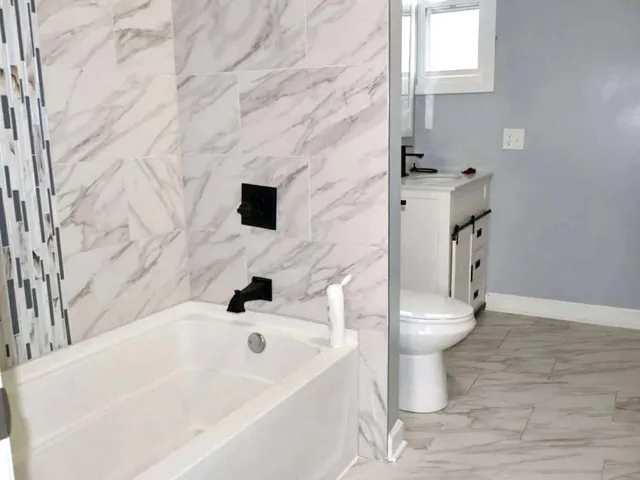 a bathroom with a toilet and a sink