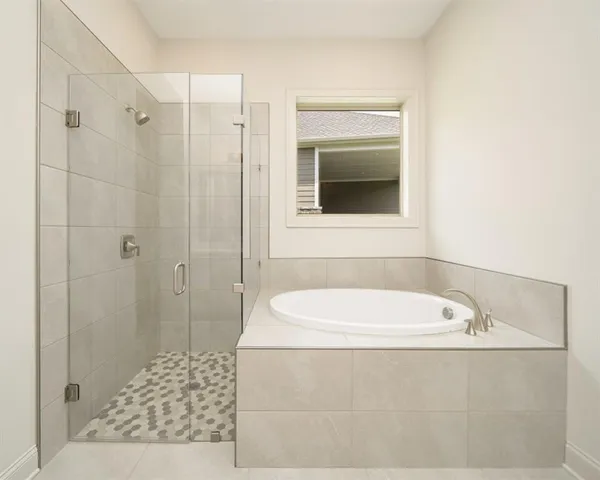 a bathroom with a bathtub and a shower