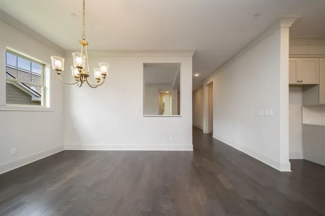 a view of livingroom with chandelier and wooden floor