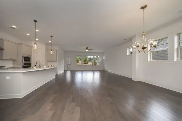 a view of a kitchen with stove and wooden floor