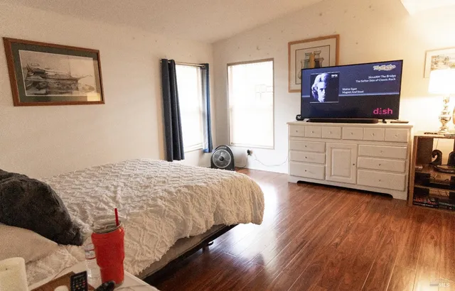 a bedroom with a bed and a television