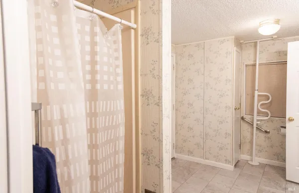 a bathroom with a shower and a glass door