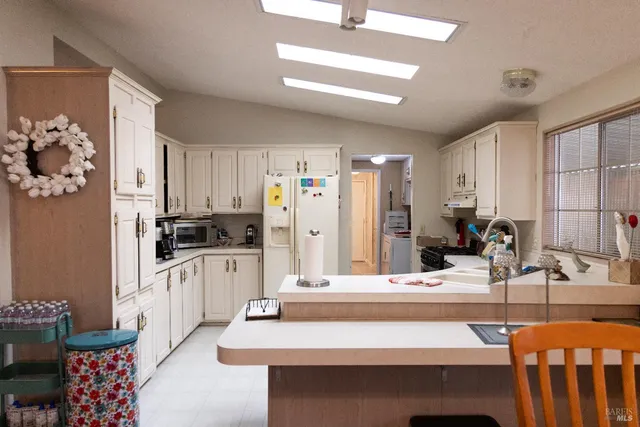 a kitchen with stainless steel appliances kitchen island granite countertop a sink and cabinets