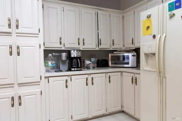 a kitchen with stainless steel appliances a white cabinets and a window