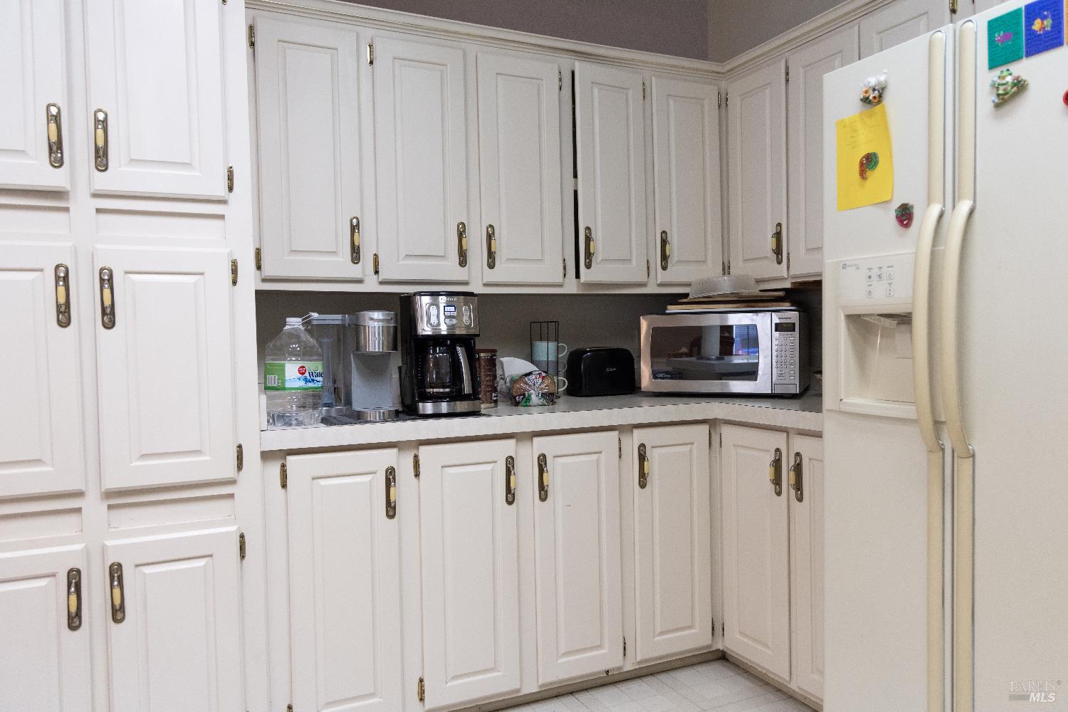 171 Colonial Park Drive Santa Rosa, CA 95403 - Photo 21 of 29 a kitchen with stainless steel appliances a white cabinets and a window
