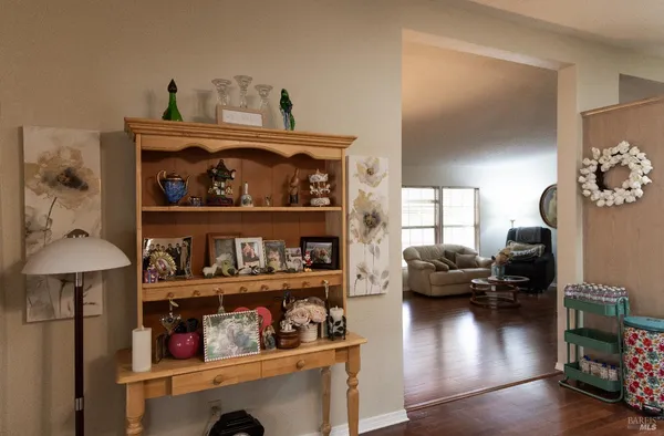a living room with lots of furniture and a wooden floor