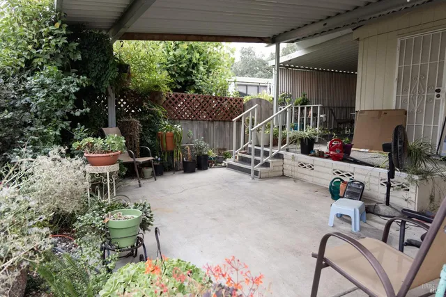 a patio with table and chairs
