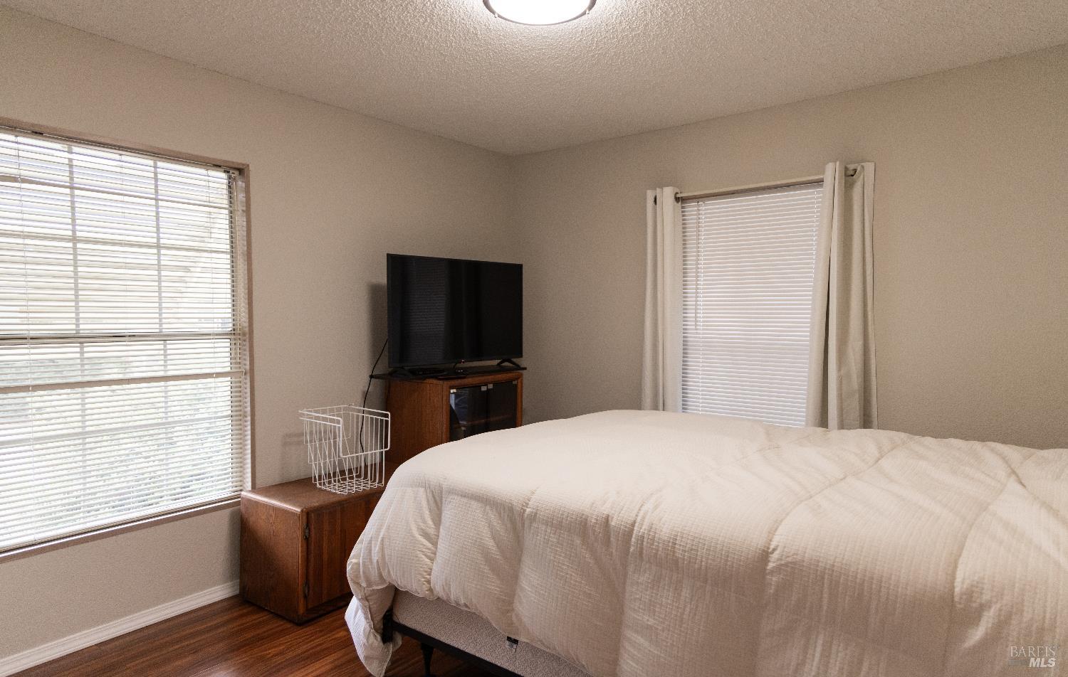 171 Colonial Park Drive Santa Rosa, CA 95403 - Photo 5 of 29 a bedroom with a bed and a flat screen tv
