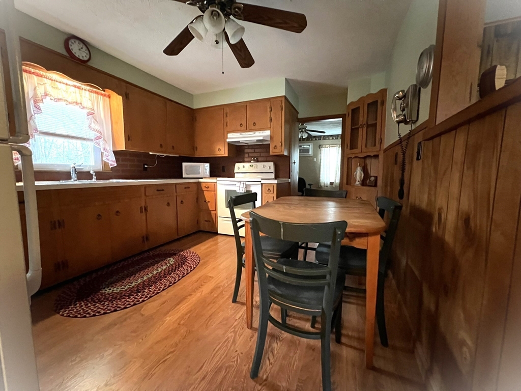 18 Eastern Avenue Webster, MA 01570 - Photo 13 of 36 a kitchen with a dining table chairs and large window
